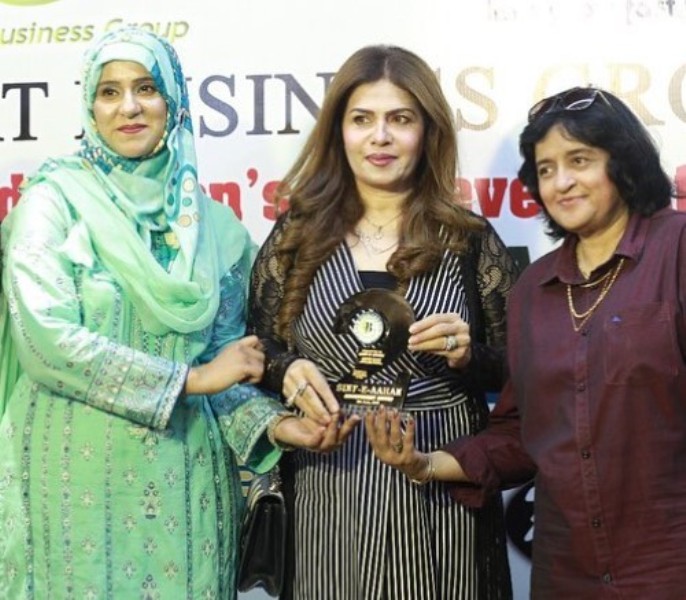 Amber Khan (center) while receiving SINF-E-AAHAN Award