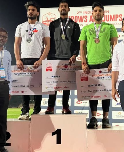Kishore Jena (centre) after winning gold at the 2nd Indian Open Throws Competition