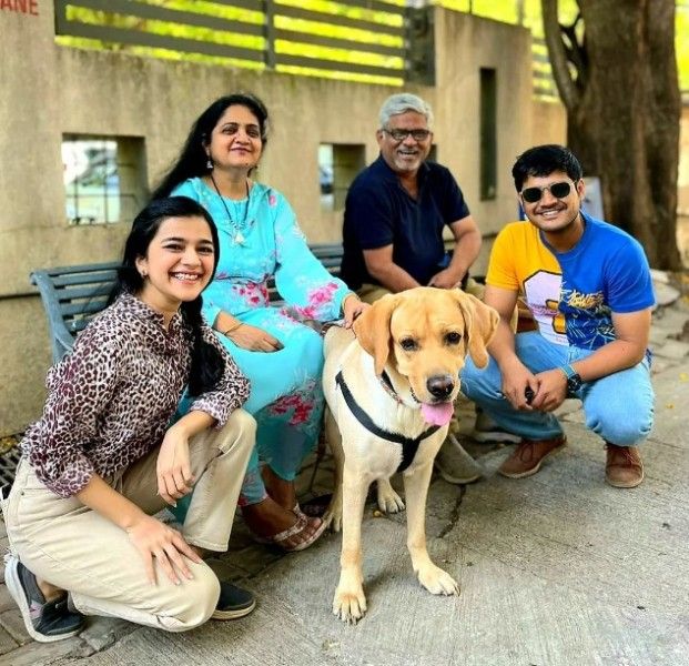 Krutika Deo, her mother-in-law, Vaishali Deshmukh, father-in-law, Satish Deshmukh, and husband, Abhishek Deshmukh (left to right) with her pet dog, Dash