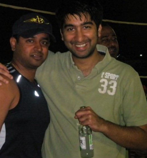 Mithun Sacheti (right) posing with a bottle of beer