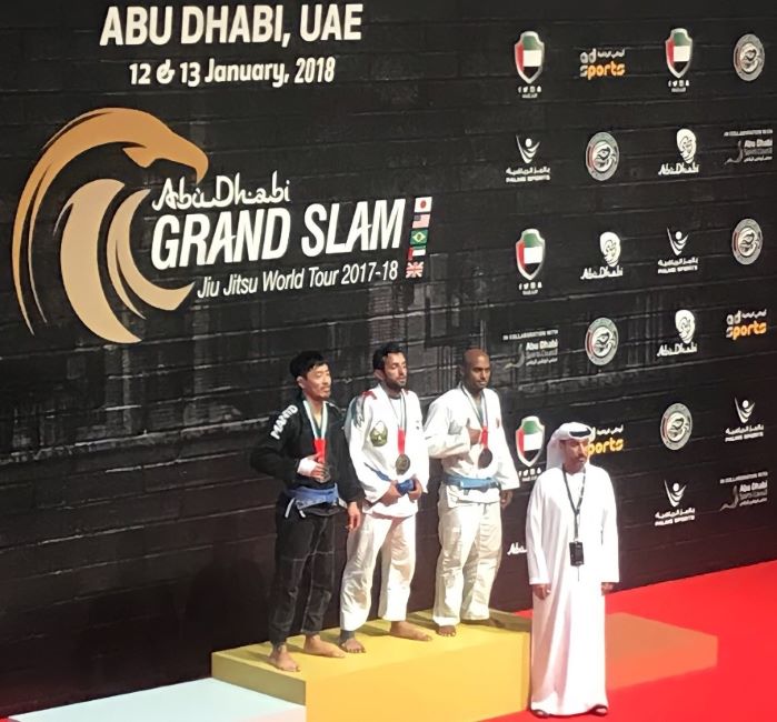 Neyadi with his medal (in the middle) posing for a photo at the Abu Dhabi Grand Slam Jiu-Jitsu World Tour 2017-2018