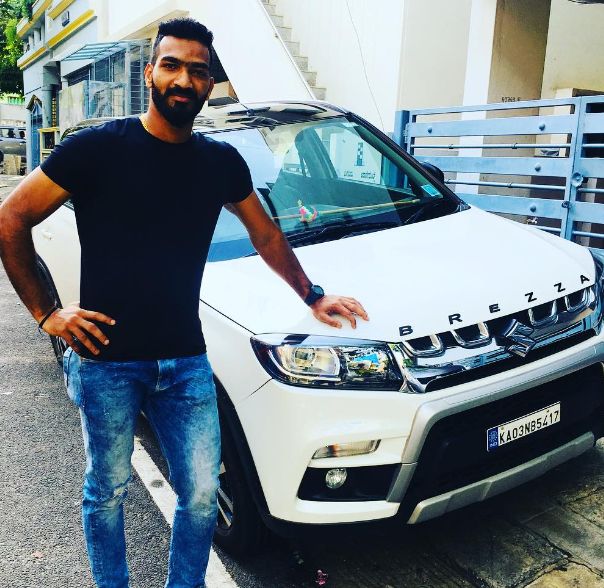 Sukesh Hegde posing with his car