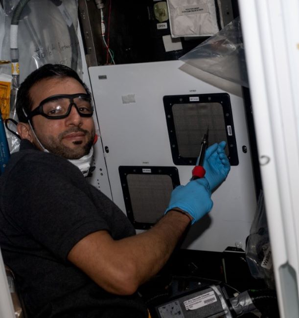 Sultan working on a project onboard the ISS