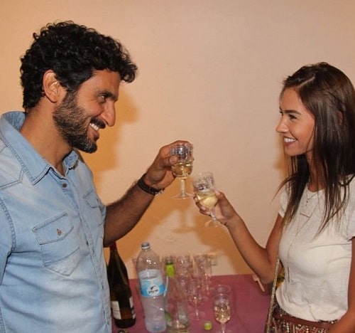 Tsahi Halevi holding a glass of alcohol