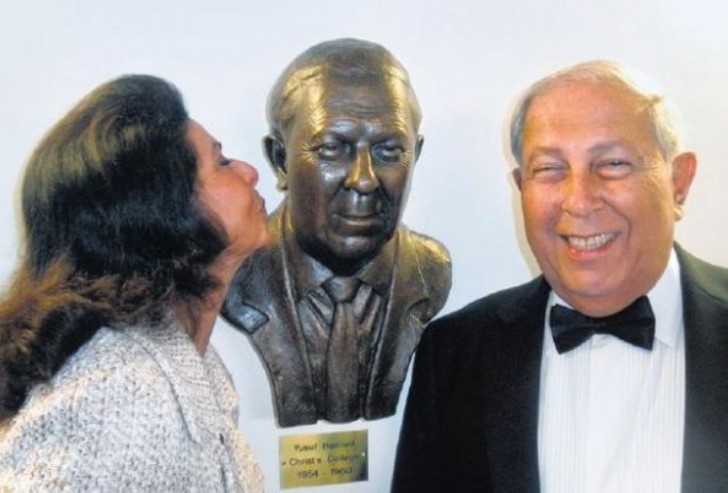 Yusuf's wife Farida Hamied while kissing her husband's statue