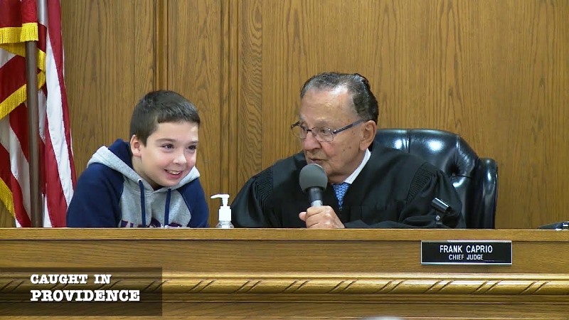 A still from the TV show Caught in Providence featuring Judge Frank Caprio with a child