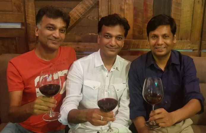 Mukesh Singh (right) with his friends holding a glass of wine