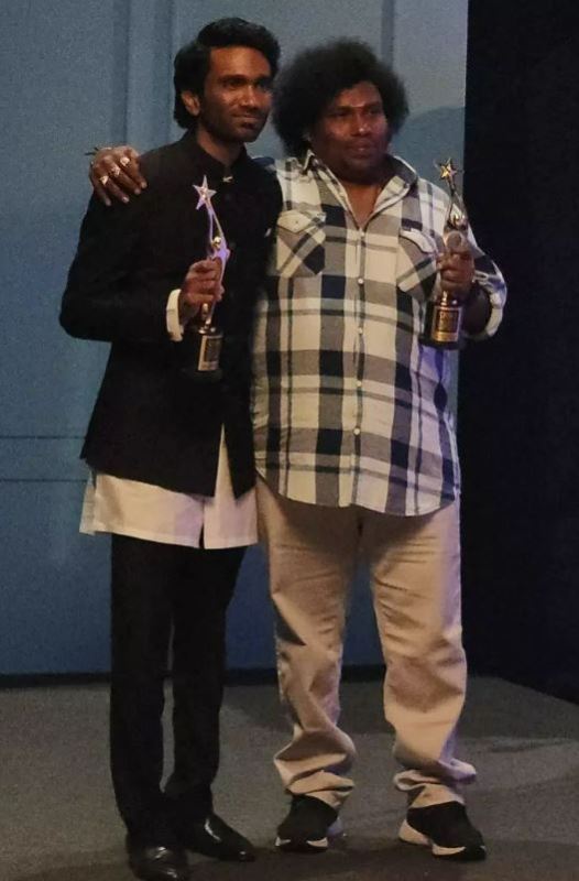 Yogi Babu (right) after winning the Best Comedian Award at SIIMA 2023