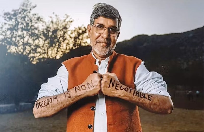 A photo of Kailash Satyarthi with slogans written on his arms