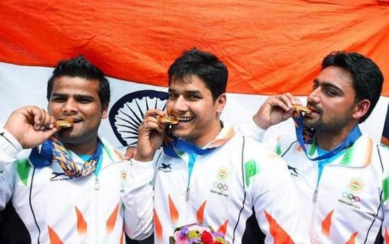 Abhishek Verma (centre) at the 2014 Asian Games posing with gold medal in the men's compound archery team competition