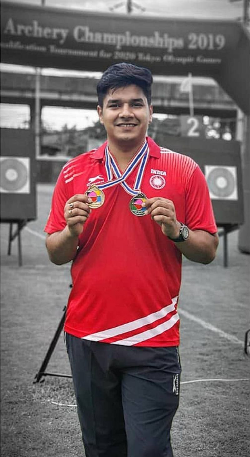 Abhishek Verma posing with gold (individual) and silver (team) medals at the Asian Archery Championship 2019