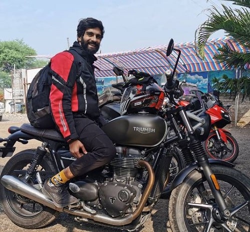 Kunal Thakur sitting on his motorcycle