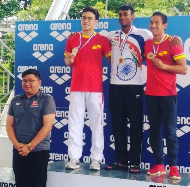 Likith Selvaraj (centre) after winning a gold medal in the 62nd Malaysia Open Swimming Championships