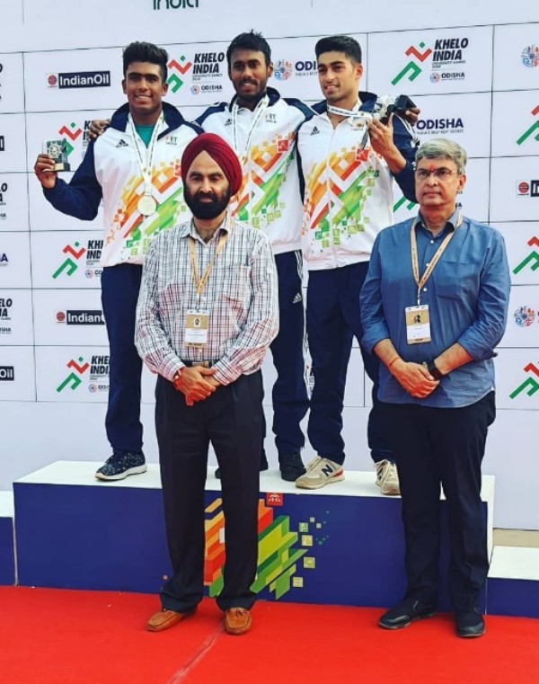 Likith Selvaraj (centre) after winning a gold medal in the Khelo India University Games