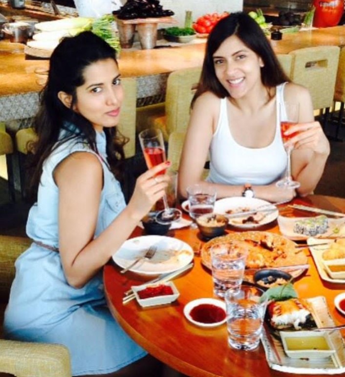 Manasvi Mamgai (left) drinking wine during a party