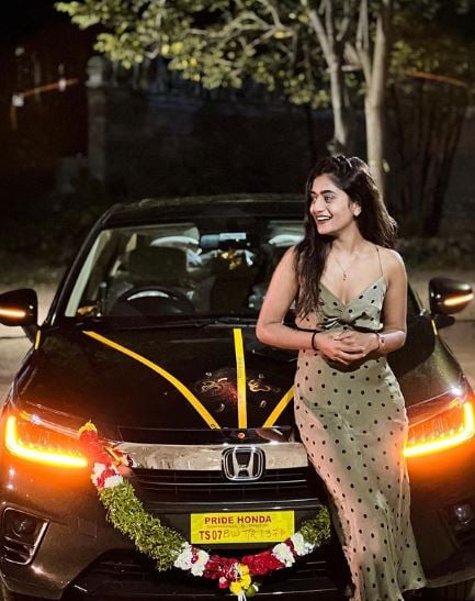 Nayani Pavani posing with her car
