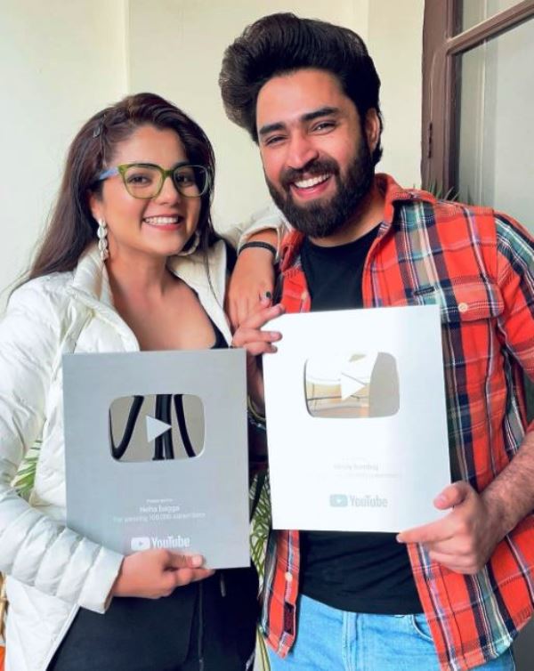Neha Bagga and Resty Kamboj posing with their YouTube Silver Play Buttons for their self-titled channels