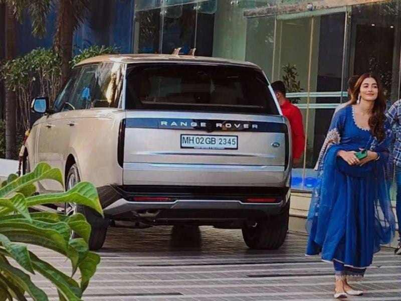 Pooja Hegde while posing with her Land Rover Range Rover luxury SUV