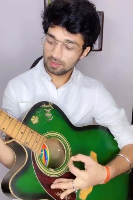 Manish Gaharwar while playing a guitar