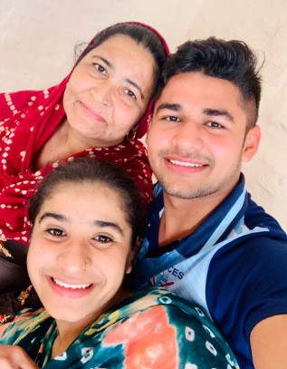 Naveen Kumar with his mother and sister