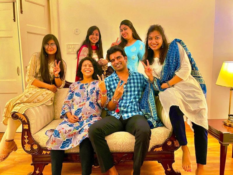 A photo of Abhishek taken with his sisters and Durga (seated next to him)