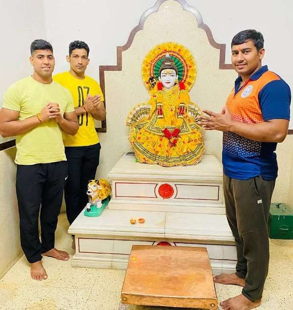 Naveen Kumar (left) worshipping in a temple