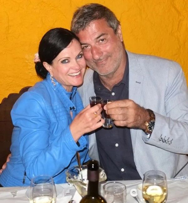 Paolo Macchiarini holding a small glass of alcohol