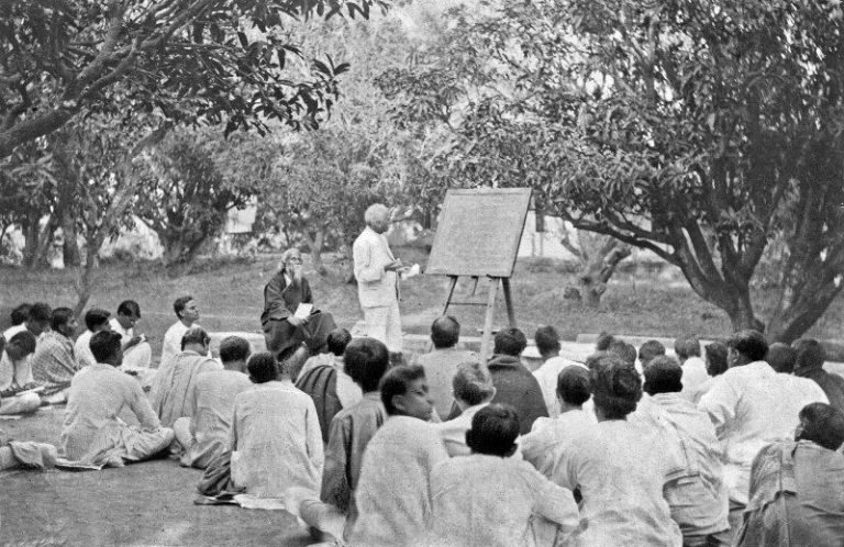 Rabindranath Tagore (seated, to the left of man at blackboard) at an open-air classroom, Shantiniketan, West Bengal