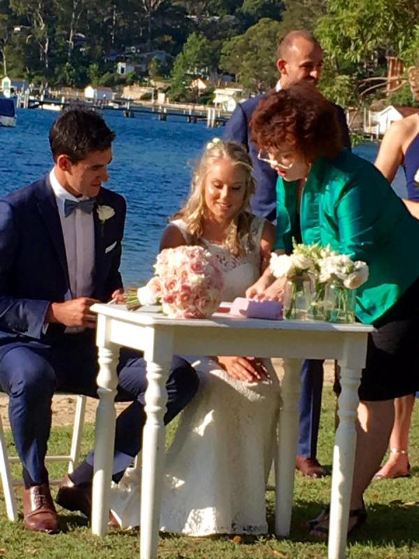 Mitchell Starc and Alyssa Healy signing their wedding document