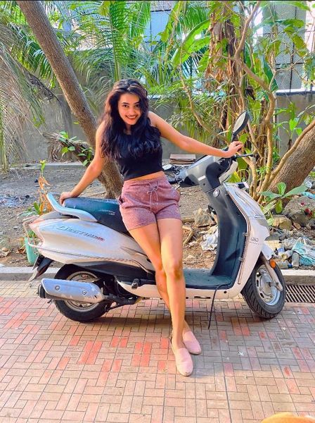 Pooja Katurde posing with her scooter