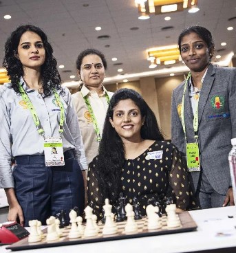Koneru Humpy with her teammates posing after winning a bronze in the 2022 Chess Olympiad