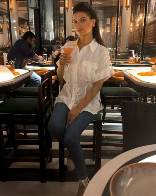 Karuna Gidwani holding a glass of alcohol