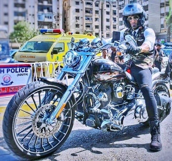 Mohib Mirza sitting on his Harley Davidson