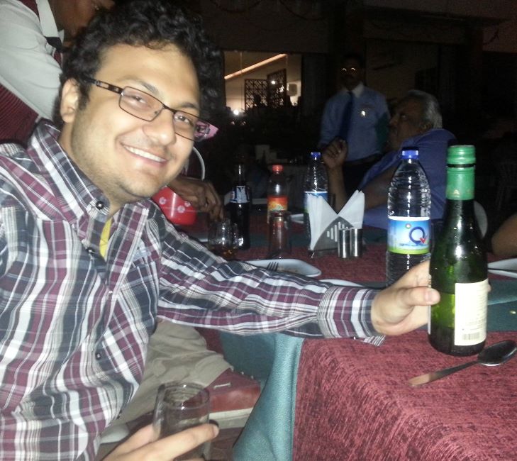 Sagar Shah holding a bottle of alcohol