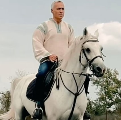 Călin Georgescu while riding a horse