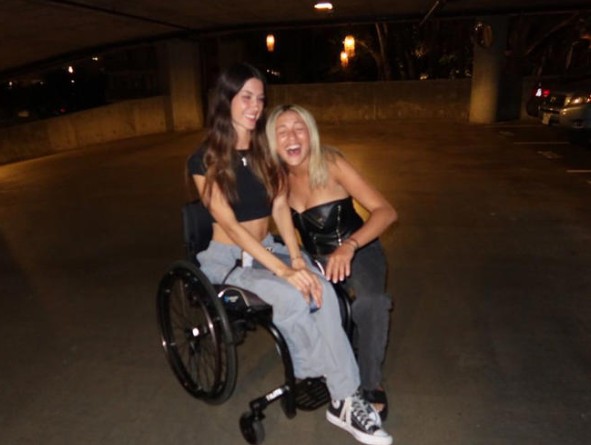 A picture of Isabelle Tate posing on a wheelchair
