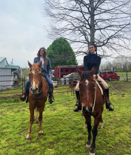 Isabelle Tate while riding a horse with her sister