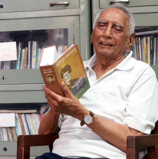 Baba Adhav while reading a book