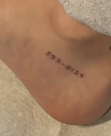Madison Beer's 555-0134 tattoo on her right foot