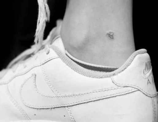 Madison Beer's Tiny Bee tattoo on the inner side of her right ankle