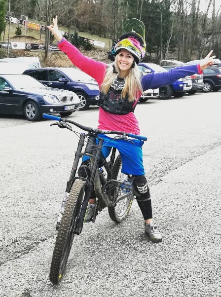 Michaela Benthaus posing with her bicycle