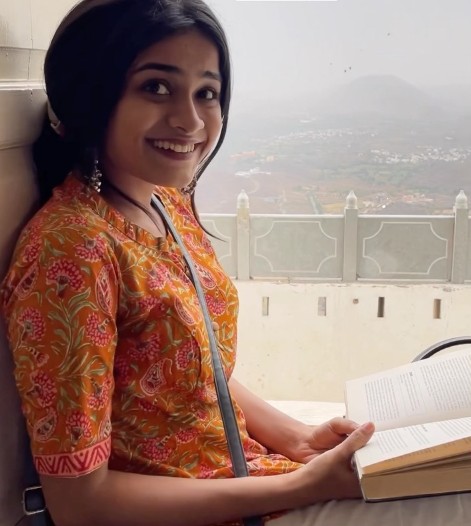 Reeva Rachh while reading a book during a trip