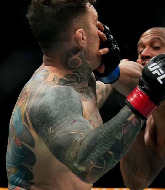 Tattoos on Tom Aspinall's arms