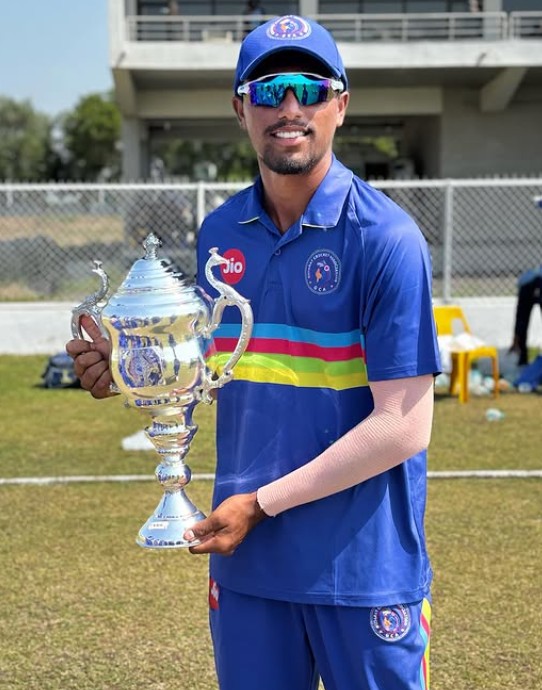 Henil Patel posing with the Vinoo Mankad Trophy for the 2024-2025 U-19 season