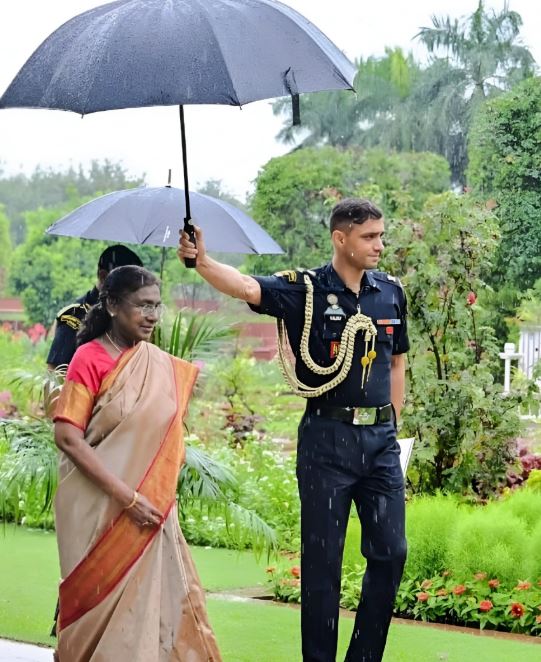Major Rishabh Singh, while holding an umbrella for the president, Droupadi Murmu
