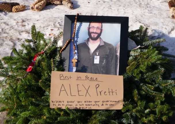A wreath surrounds an image of Alex Pretti at the makeshift memorial near the site where he was shot by federal agents, in Minneapolis, Minnesota, US, on 26 January 2026
