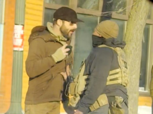 Alex Pretti while holding a phone during a conversation with an officer