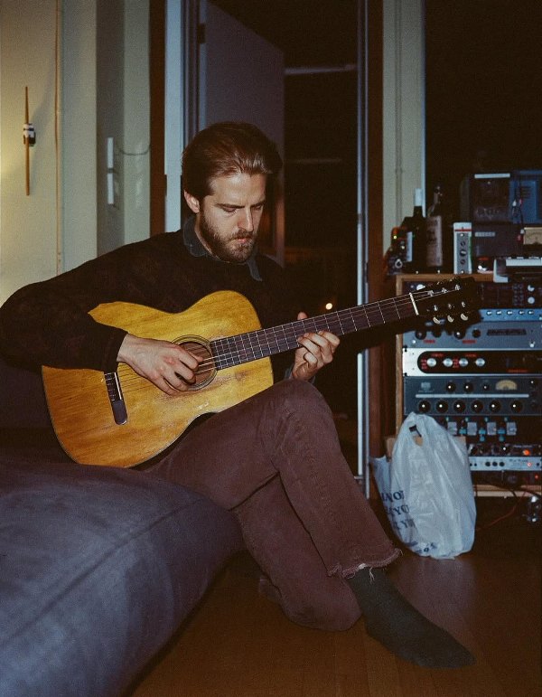 Christian Lee Hutson while playing the guitar