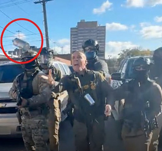 Gregory Bovino with his officers while throwing a tear gas canister at protesters in Little Village, Chicago