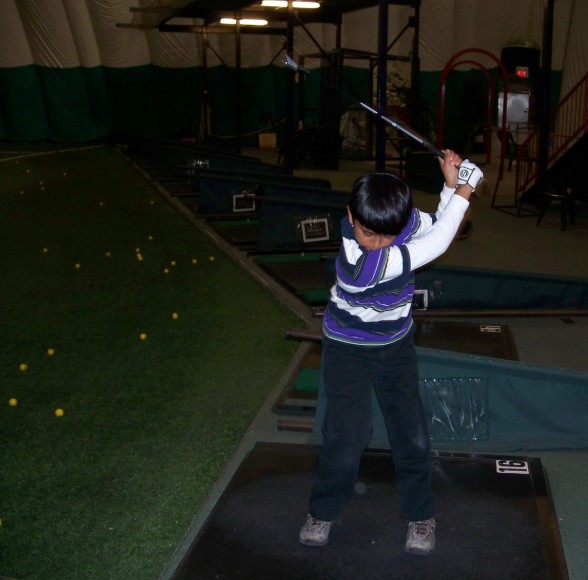 A childhood picture of Sudarshan Yellamaraju while practising golf at a golf dome